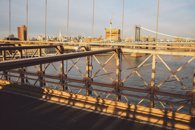 Brooklyn bridge over east river against sky