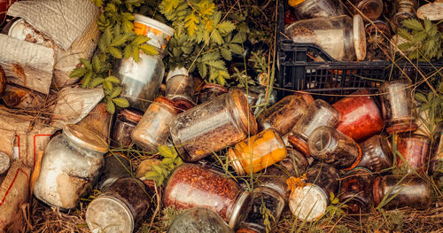 High angle view of abandoned jars on ground