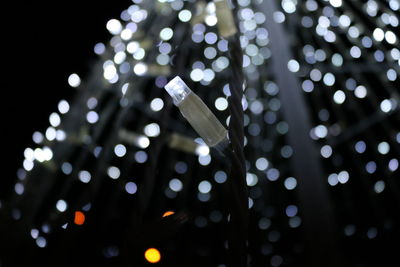 Illuminated light bulb against defocused lights