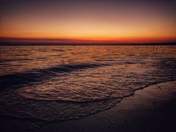 Scenic view of beach against sky during sunset