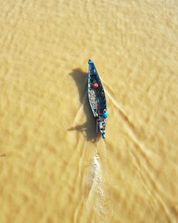 Longtail boat sailing on river