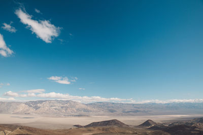 Scenic view of mountains against blue sky