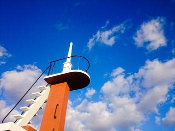 Low angle view of crane against blue sky