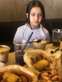 Portrait of a girl having food in restaurant