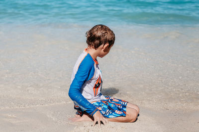 Rear view of boy on beach