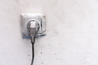 Close-up of electric lamp on wall