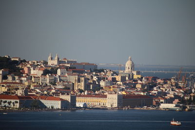 Buildings in city against clear sky