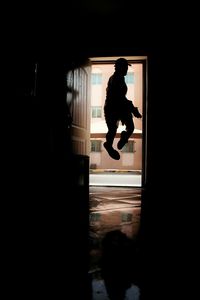 Silhouette of woman in dark room