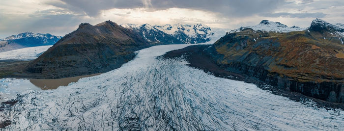 Beautiful glaciers flow through the mountains in iceland.