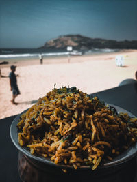 Close-up of food on beach against sky