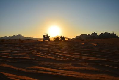 Scenic view of desert against sky during sunset