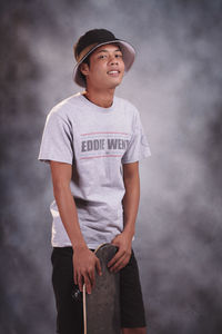 Portrait of young man standing against sky