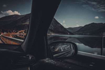 View of mountains seen through car windshield