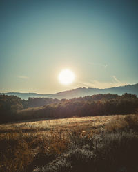 Scenic view of field against sky during sunset