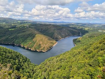 High angle view of river amidst trees against sky