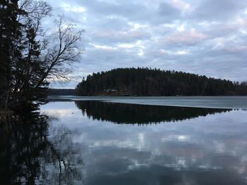 Scenic view of lake in forest against sky