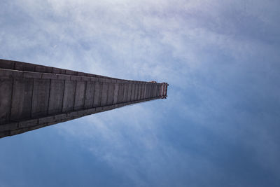 Low angle view of tower against cloudy sky