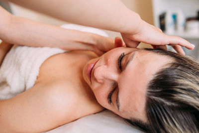 Cropped image of doctor examining patient at spa