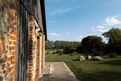 Panoramic shot of road by building against sky