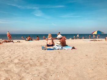 People relaxing on beach