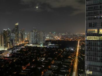 Aerial view of illuminated buildings in city at night