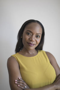 Portrait of a smiling young woman over white background