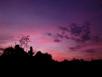 Low angle view of silhouette trees against sky at sunset