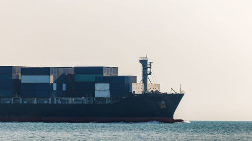 Boats in sea against clear sky