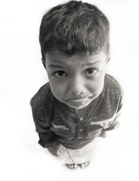 Portrait of cute boy against white background
