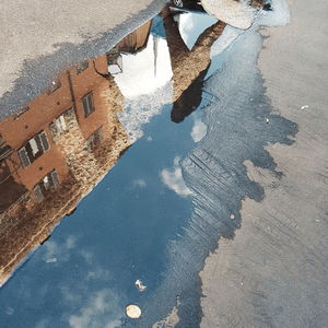 Reflection of buildings on puddle