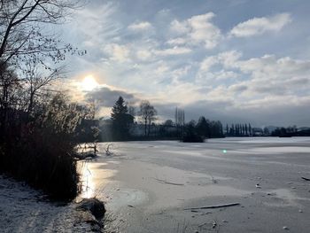 Scenic view of frozen lake against sky during winter