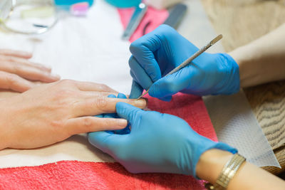 Midsection of doctor examining patient on bed