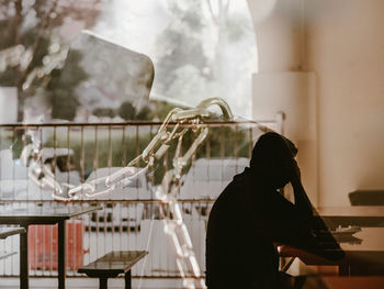 Side view of a man in deep thought by the window