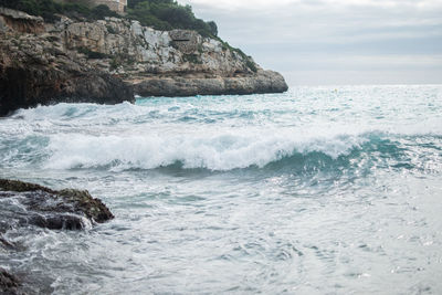 Scenic view of sea against cloudy sky