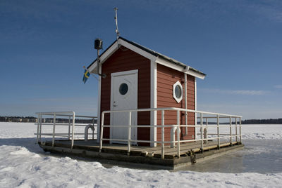 Built structure on beach against sky during winter