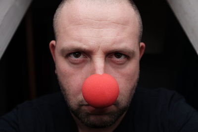 Close-up portrait of man wearing clown