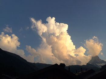 Scenic view of mountains against cloudy sky