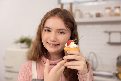 Portrait of smiling woman holding ice cream