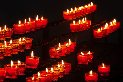 Close-up of illuminated candles in temple