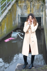 Full length of woman standing in snow