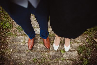 Low section of couple standing outdoors