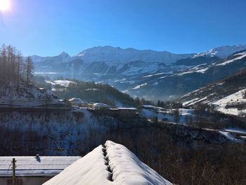 Scenic view of snow covered mountains against clear sky