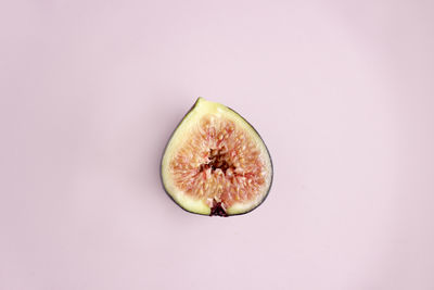 Close-up of fruit against colored background