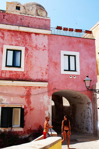 Rear view of people walking on building