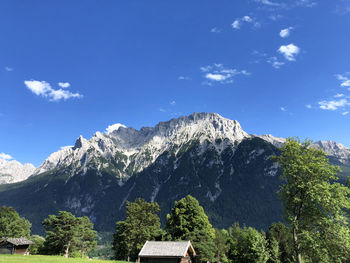 Scenic view of mountains and trees against sky