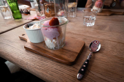 Glass of ice cream on table