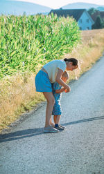 Full length of woman walking on road