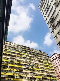 Low angle view of building against cloudy sky