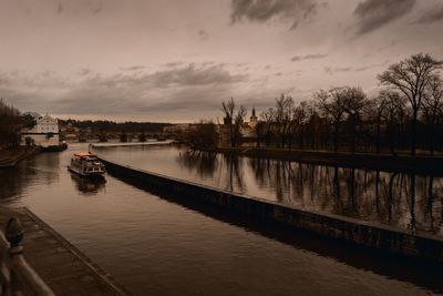 Boats in river with city in background