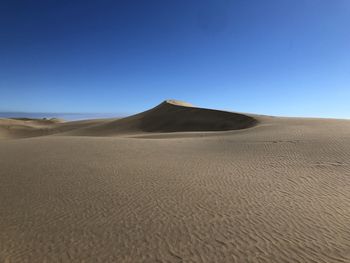 Scenic view of desert against clear sky